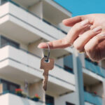 Real estate agent holding keys to new flat. Real estate, buy a home concept
